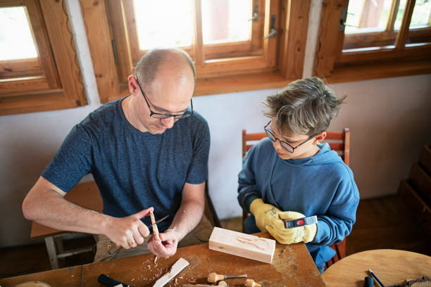 Father and son learning carving wood