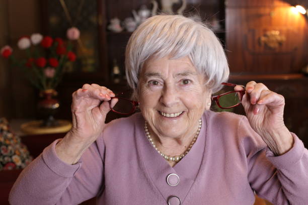 istock Senior woman using clic magnetic reading glasses 1318435595