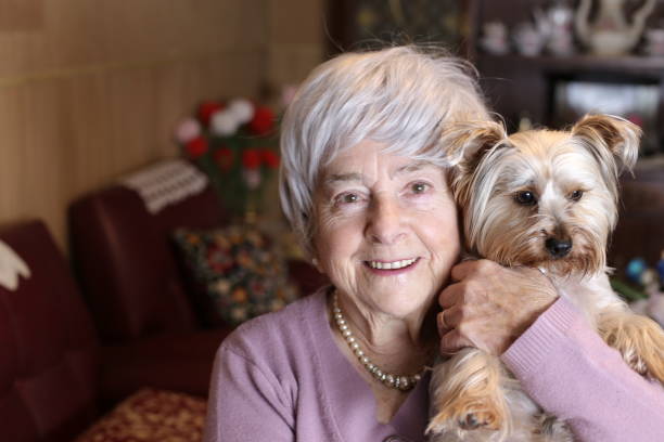 istock Tender senior woman holding Yorkshire terrier 1318435648