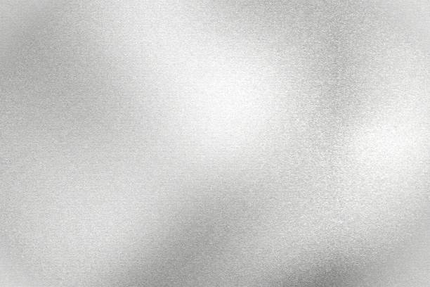 istock Light shining on silver painted metal wall with copy space, abstract texture background 1318440283