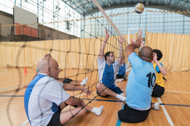 istock Disabled athletes  volley teams on a  ball blocking play 1318440559
