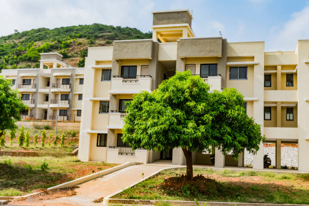 istock A five floor building just completed it's construction near by bitumen highway road looking beautiful with a small mango tree in fronts of building. 1318440932