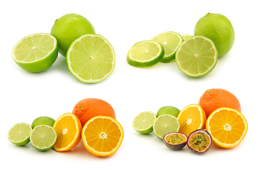 An overhead view of a collection of citrus fruit, including various types of grapefruit, oranges, limes and lemons.