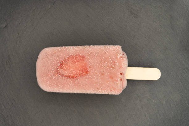 istock top view fresh milk flavor popsicle with strawberry slice on dark 1318441697