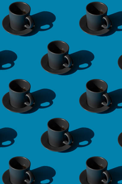 istock Cup of espresso coffee on a blue background pattern. Minimal concept. 1318442035