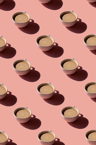 istock Cup of coffee pattern on pink background. Sunlight minimal trendy concept 1318442038