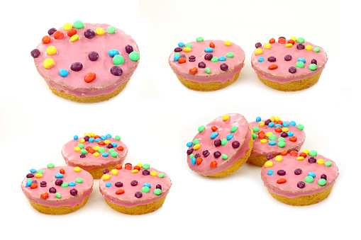 festive cakes with pink icing and colorful sprinkles on a white background