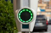 A battery charging point for electric cars, illuminated with green LEDs, in the area of the Retiro district, in Madrid, Spain.
