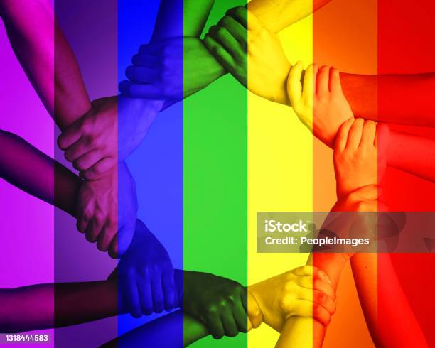 Cropped Shot Of Unrecognizable People Linking Arms Against A Multi Colored Overlay Stock Photo - Download Image Now