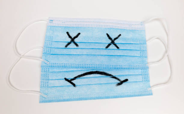 istock mask with sad eyes and face covid disaster 1318446368