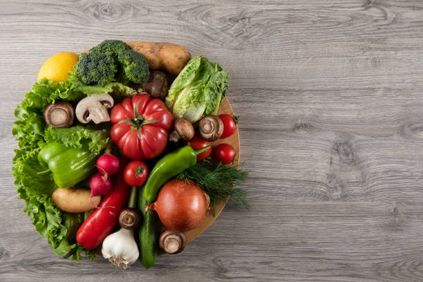 istock Fresh Vegetables on Wooden Kitchen Table 1318447283