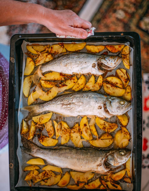 She is Holding Baked Fish on the Tray