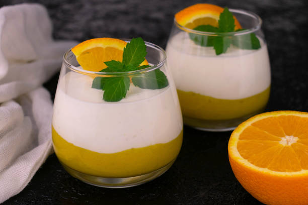istock Orange mousse with yogurt.Orange dessert with takanah on a black background. 1318449087