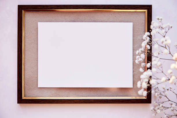istock Brown frame mockup on vintage surface. Vintage frame with gypsophila. Beige background, Scandinavian interior. Top view. Place for advertising, thank you or wishing 1318450426