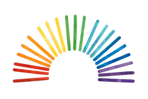 istock Rainbow color wooden ice cream sticks on white. 1318451817