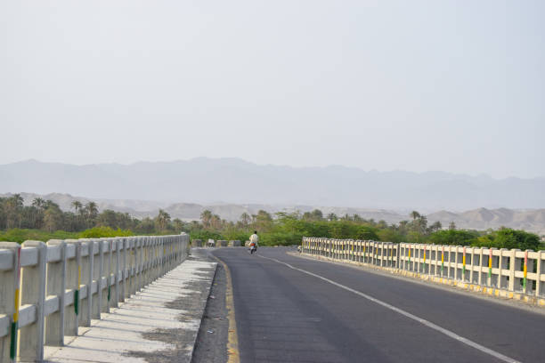 istock landscape highway blue sky scenery, river side mountain view daylight nature environment weather Turbat bridge Jusak Raod Balochsitan background wallpaper 1318452964