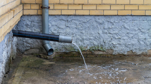 istock A drain with water running down from the roof during rain 1318454048