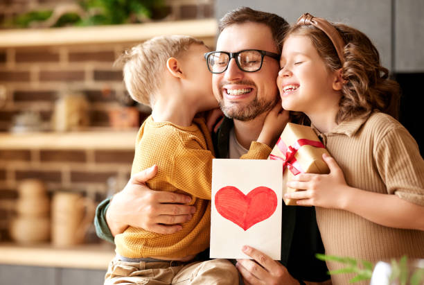 istock Cute children congratulating happy daddy with Fathers day and gi 1318454061