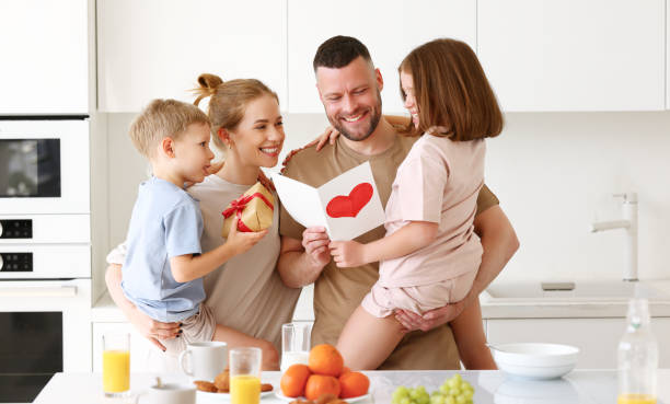istock Little sibling congratulating daddy with Fathers day at home 1318454644