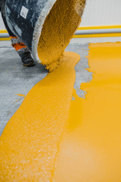 istock Worker applying epoxy and polyurethane flooring system.These easy-to-clean products also have non-slip features. 1318455664