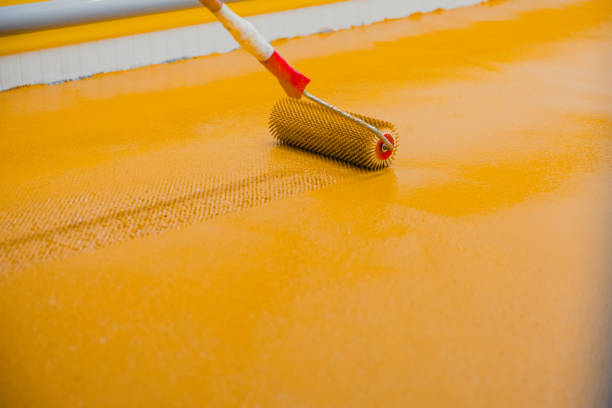 istock Worker applying epoxy and polyurethane flooring system.These easy-to-clean products also have non-slip features. 1318456005