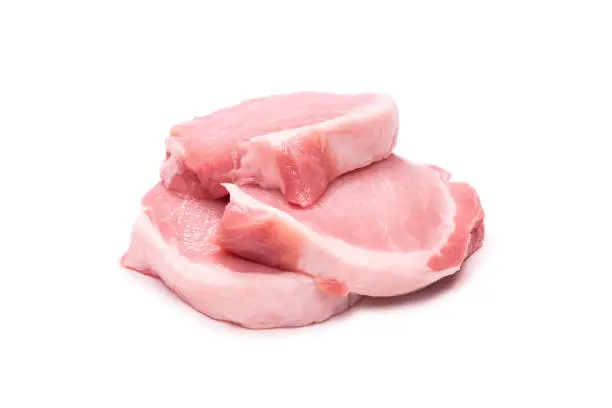 Raw pork pieces isolated on a white background. Top view.