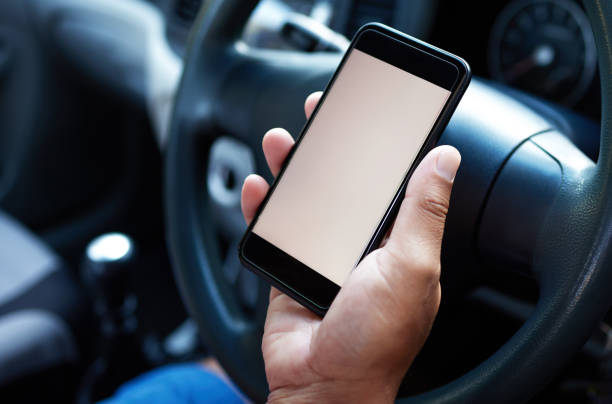 istock Shot of someone siting in their car using their mobile 1318456999