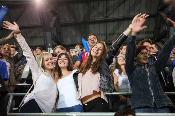 istock Friends in crowd on a stadium 1318457241