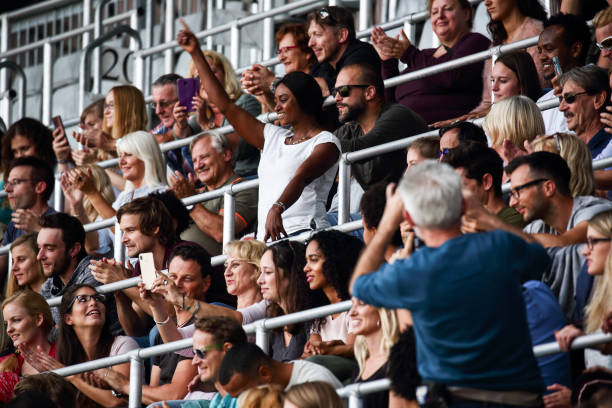 istock Standing woman in crowds on stadium 1318457337