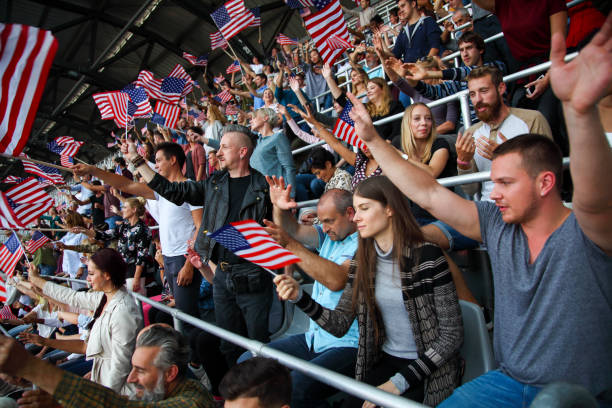 istock Spectators on a stadium with american flags 1318457375