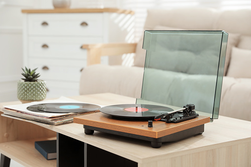 Turntable with vinyl record in living room