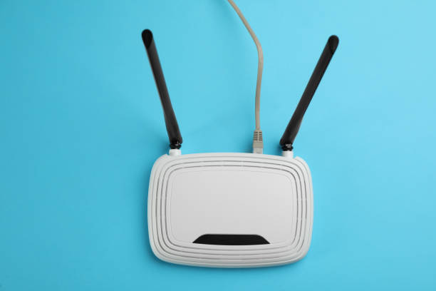 istock Modern Wi-Fi router on light blue background, top view 1318458873