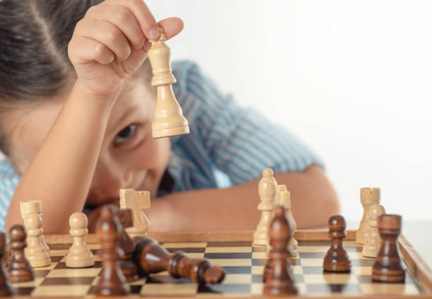 istock Girl Playing Chess 1318458960