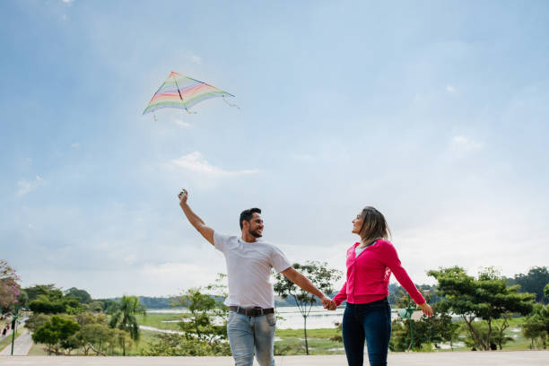 istock Couple having fun flying a kite 1318459254