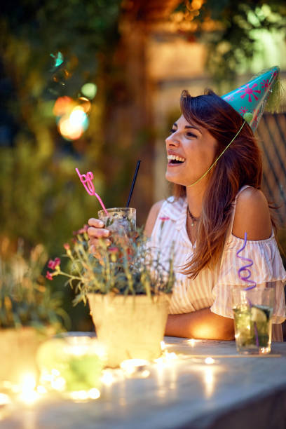 a cheerful young girl enjoying at the open air birthday party. quality friendship time together - city night lighting equipment mid air imagens e fotografias de stock