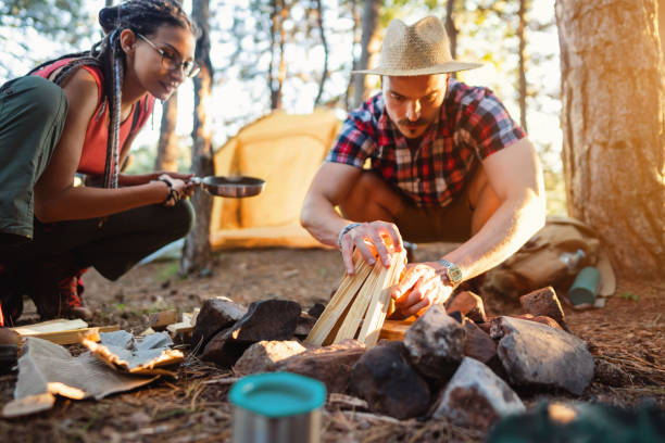 istock Cheerful young couple camping in the forest 1318461339