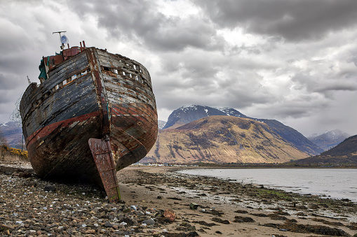 ship wreck on Loch Linnhe shore at Corpach Scotland with Ben Nevis in background