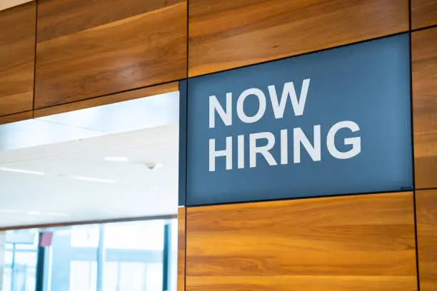 Photo of Now Hiring Open Business Job Sign