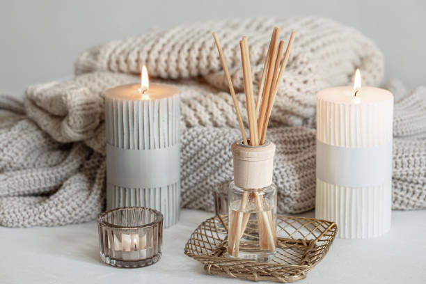 Cozy home composition with candles, aroma sticks and a knitted element. Cozy composition in Scandinavian style with decorative details for the home. household equipment stock pictures, royalty-free photos & images