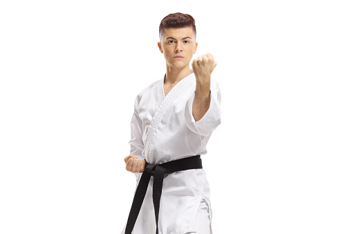 Guy practicing karate isolated on white background