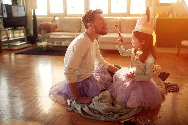 istock A little daughter and her father having a good time while putting up makeup and preparing for a ballet practice at home. Family, together, home 1318463533