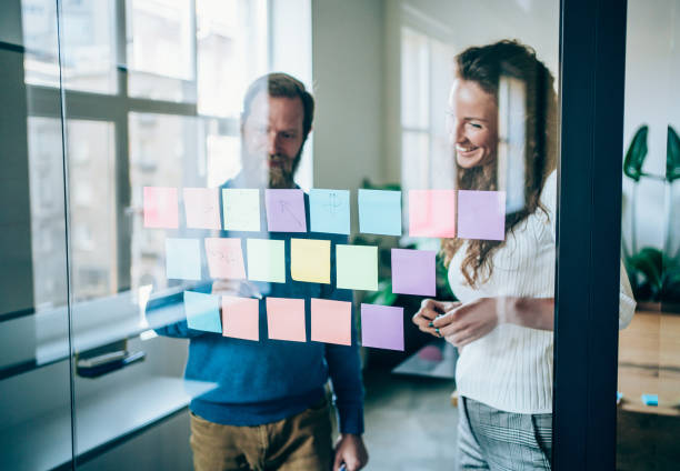 istock Businesspeople brainstorming with adhesive notes in a meeting 1318463617