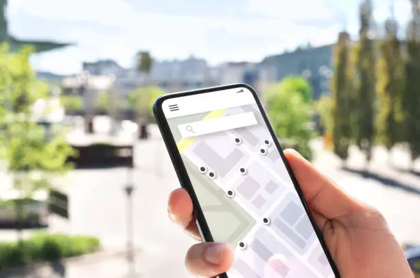 Photo of Map app in mobile phone to search location or navigate to destination in city. Place marker and pointer icon. Online GPS guide in smartphone.