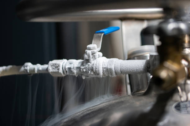 Liquid nitrogen frozen faucet and lever. Visible floating white condensation smoke from pressurized tank isolated close up shot stock photo