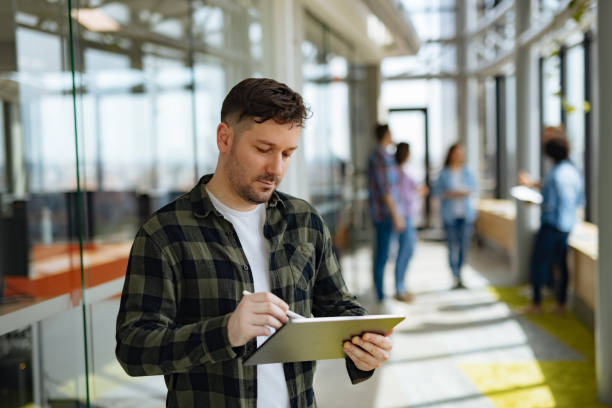 istock A successful male web designer using digital tablet in the office hallway 1318466759