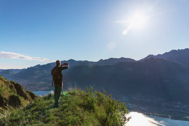 istock Solo hiker using smartphone on top of the mountain 1318466854