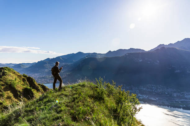 istock Solo hiker using smartphone on top of the mountain 1318466861