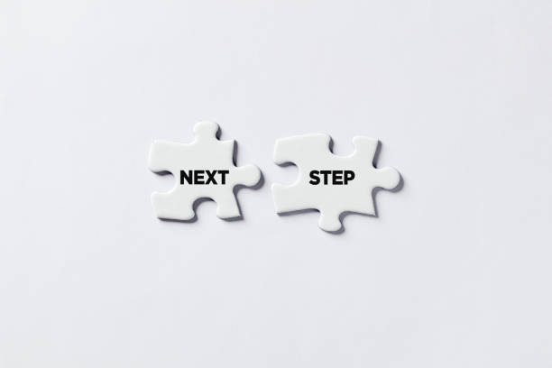 istock Jigsaw puzzle pieces with the message next step. To decide for the direction of action in business, education or life. 1318466865