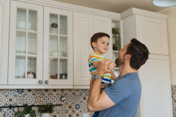 istock Young man spending quality time with his adorable son at home 1318467468