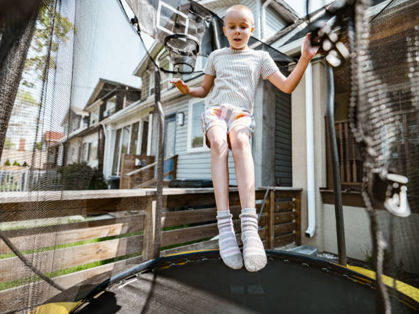 istock Young girl playing on trampoline 1318468300